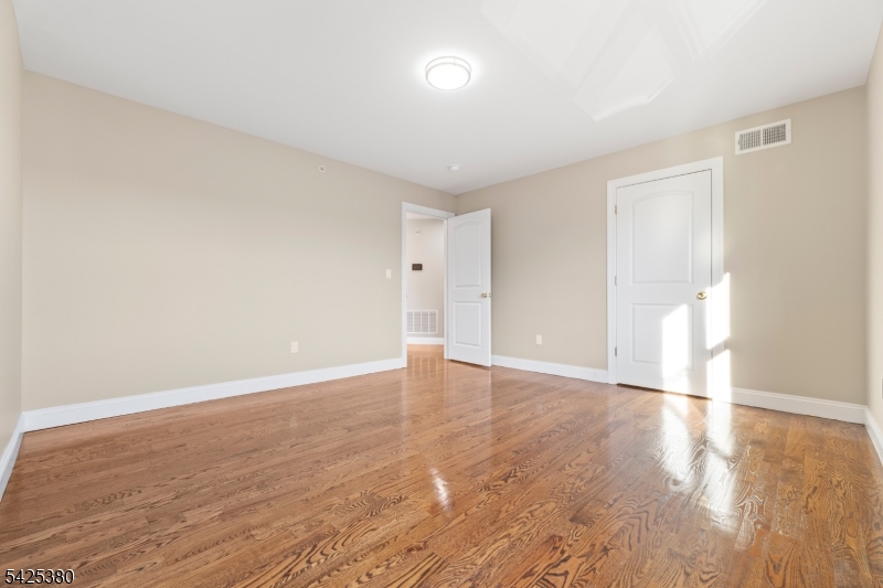 658 Market Street Paterson, NJ 07513 - Photo 8 of 19 a view of an empty room with wooden floor