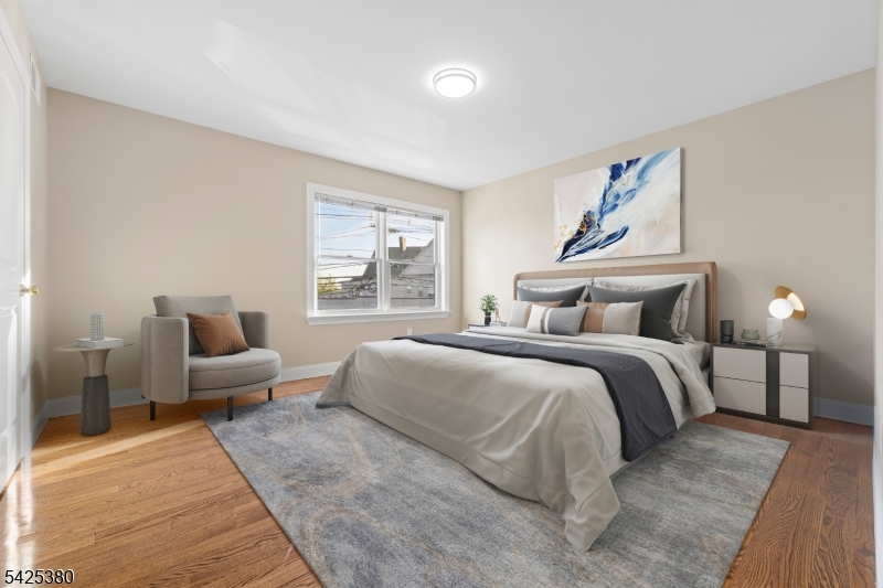 658 Market Street Paterson, NJ 07513 - Photo 9 of 19 a bedroom with a bed and wooden floor