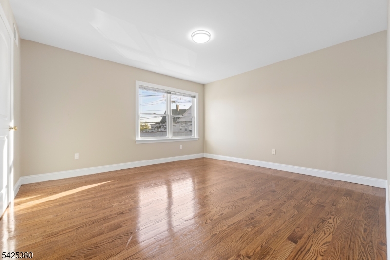 658 Market Street Paterson, NJ 07513 - Photo 10 of 19 wooden floor in an empty room with a window