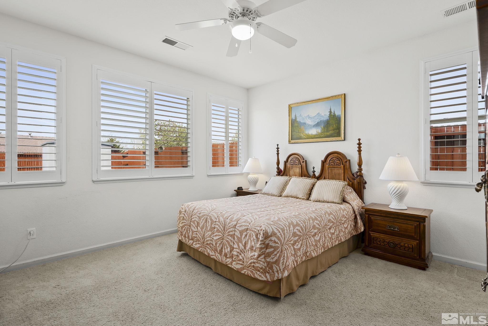 1735 Ornellaia Way Reno, NV 89521 - Photo 10 of 21 a bedroom with a bed and a chandelier