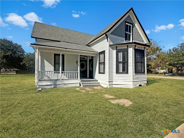 a front view of a house with a yard