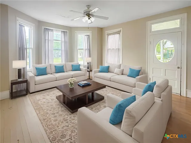 a living room with furniture and a large window