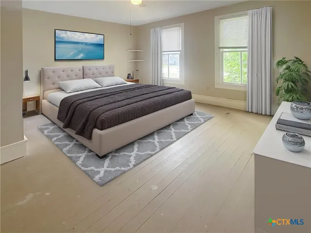 a spacious bedroom with a bed and a couch