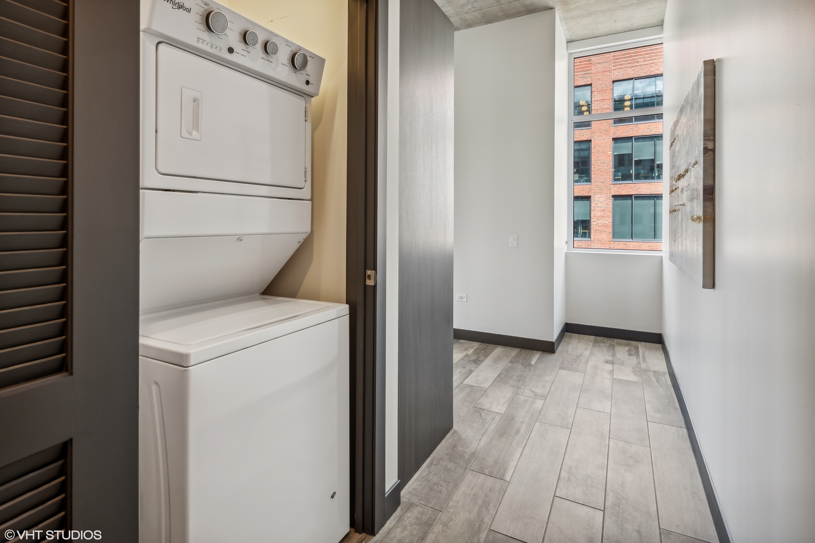 171 North Aberdeen Street, Unit 804 Chicago, IL 60607 - Photo 12 of 23 a view of washer and dryer with wooden floor