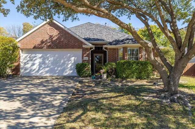 a view of a house with a tree in front