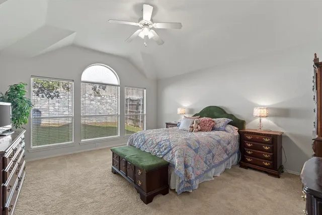 a bedroom with a large bed and a chandelier