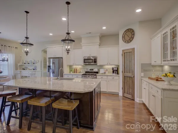 a large kitchen with a table and chairs in it