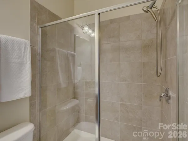 a bathroom with a shower and toilet