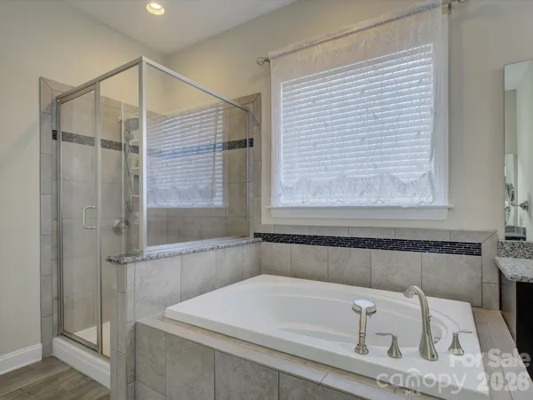 a bathroom with a bathtub and shower