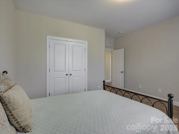 a bedroom with a bed and closet