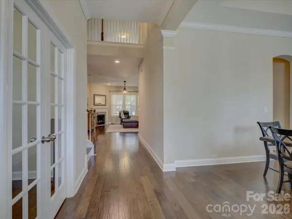 a view of a hallway with wooden floor and staircase