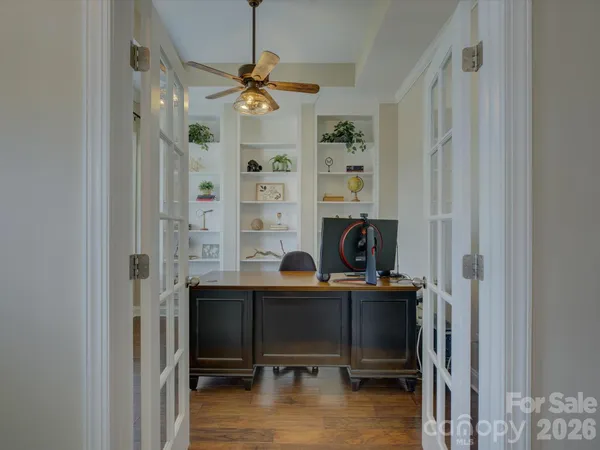 a view of a workspace with furniture and a window