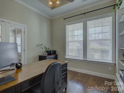 a view of a room with wooden floor and furniture