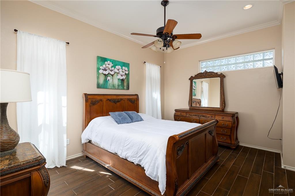818 Hill Country Road Edinburg, TX 78539 - Photo 11 of 24 a bedroom with a bed and a chandelier