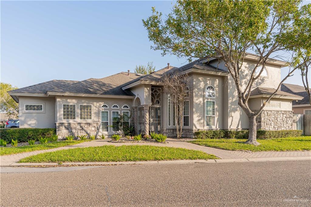 818 Hill Country Road Edinburg, TX 78539 - Photo 2 of 24 a front view of a house with a garden and trees