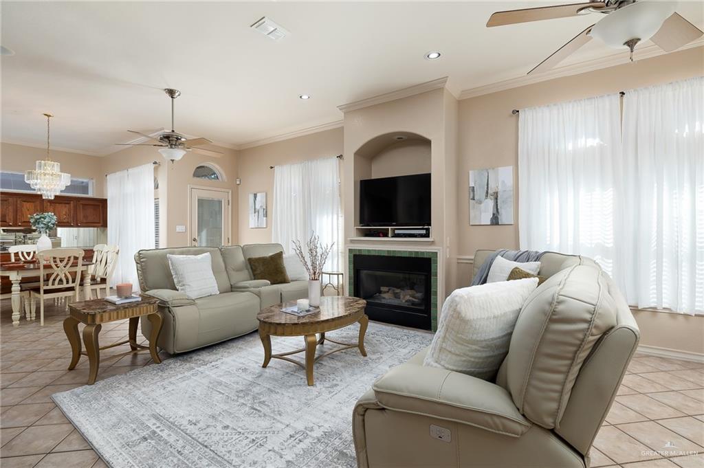 818 Hill Country Road Edinburg, TX 78539 - Photo 4 of 24 a living room with furniture a fireplace and a chandelier