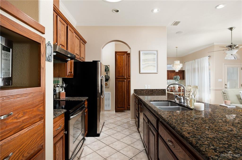 818 Hill Country Road Edinburg, TX 78539 - Photo 8 of 24 a kitchen with stainless steel appliances granite countertop a refrigerator and a sink