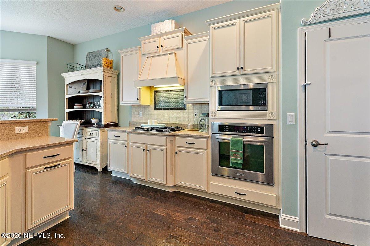 40 Pelican Pointe Road Ponte Vedra, FL 32081 - Photo 14 of 45 a kitchen with white cabinets and appliances