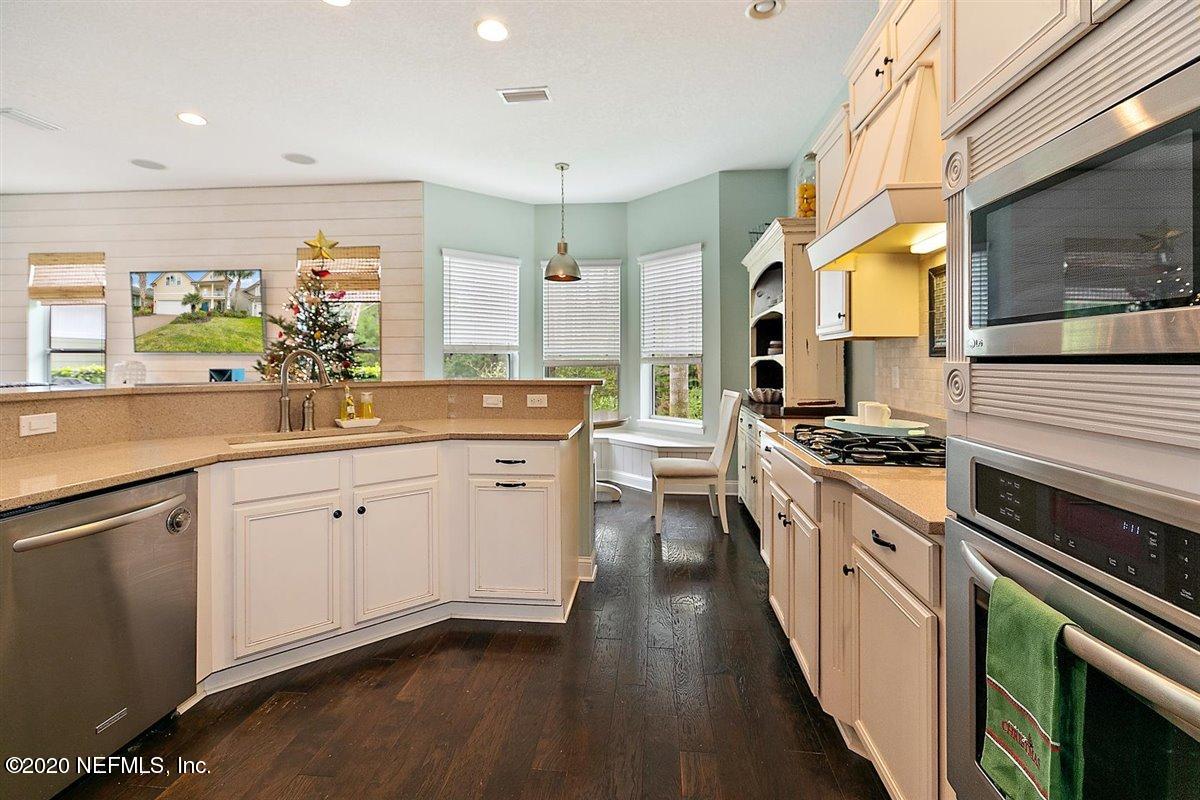 40 Pelican Pointe Road Ponte Vedra, FL 32081 - Photo 15 of 45 a kitchen with a sink stove and wooden cabinets