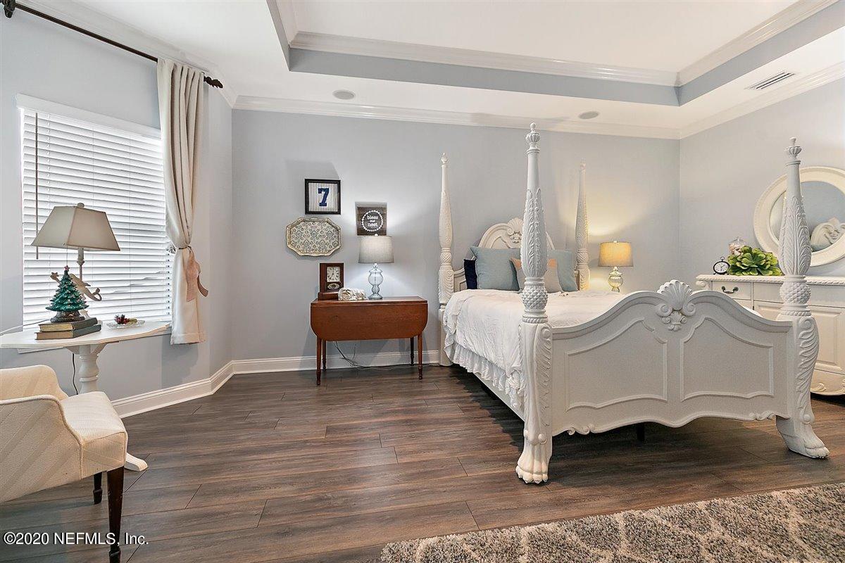 40 Pelican Pointe Road Ponte Vedra, FL 32081 - Photo 21 of 45 a bedroom with a bed and wooden floor