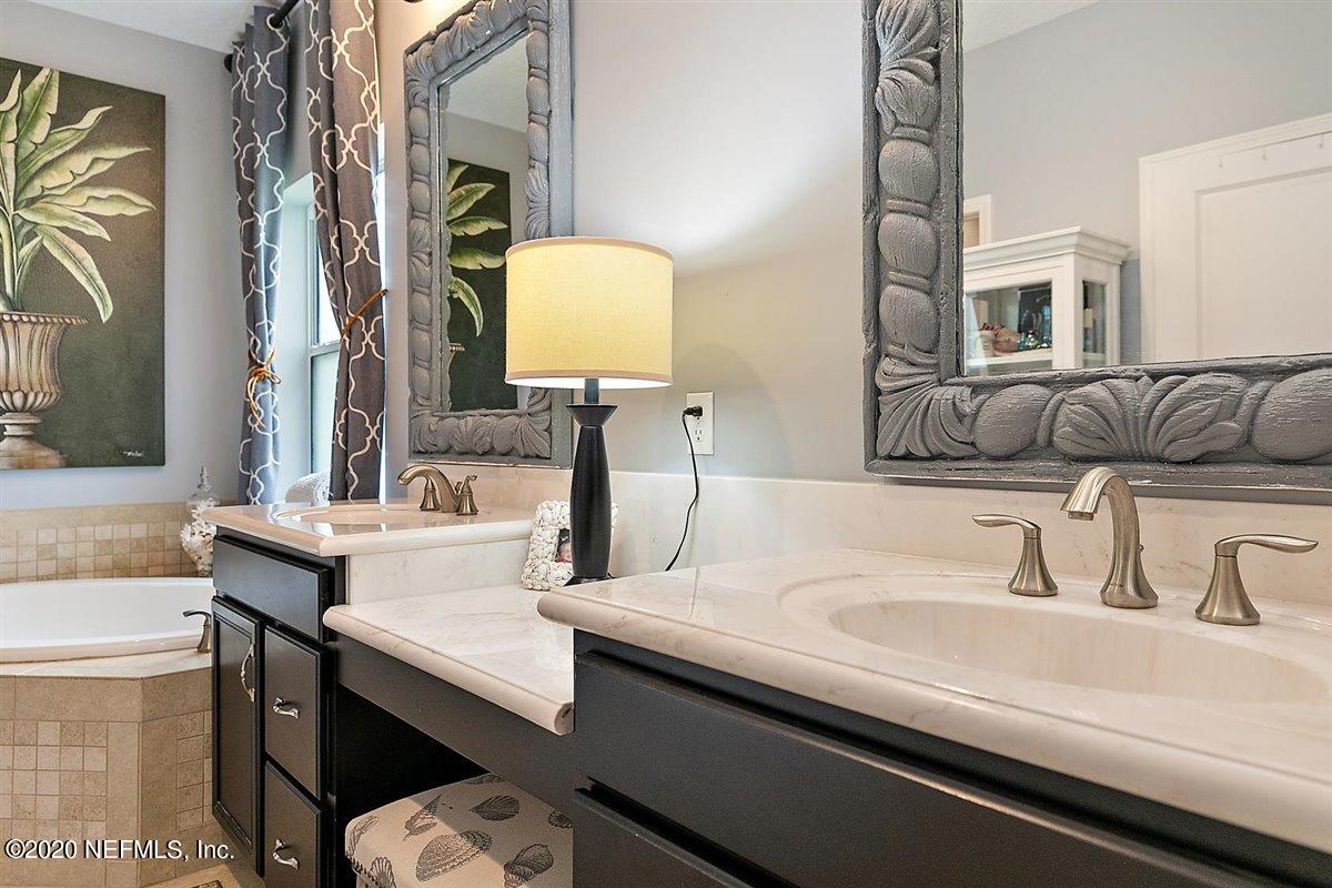 40 Pelican Pointe Road Ponte Vedra, FL 32081 - Photo 22 of 45 a bathroom with a sink and a mirror