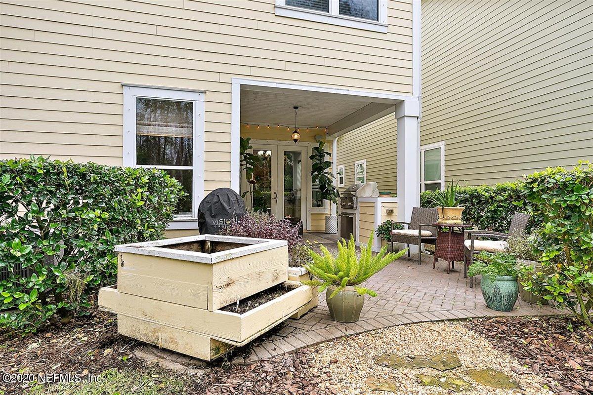 40 Pelican Pointe Road Ponte Vedra, FL 32081 - Photo 31 of 45 a white bench sitting in front of a house