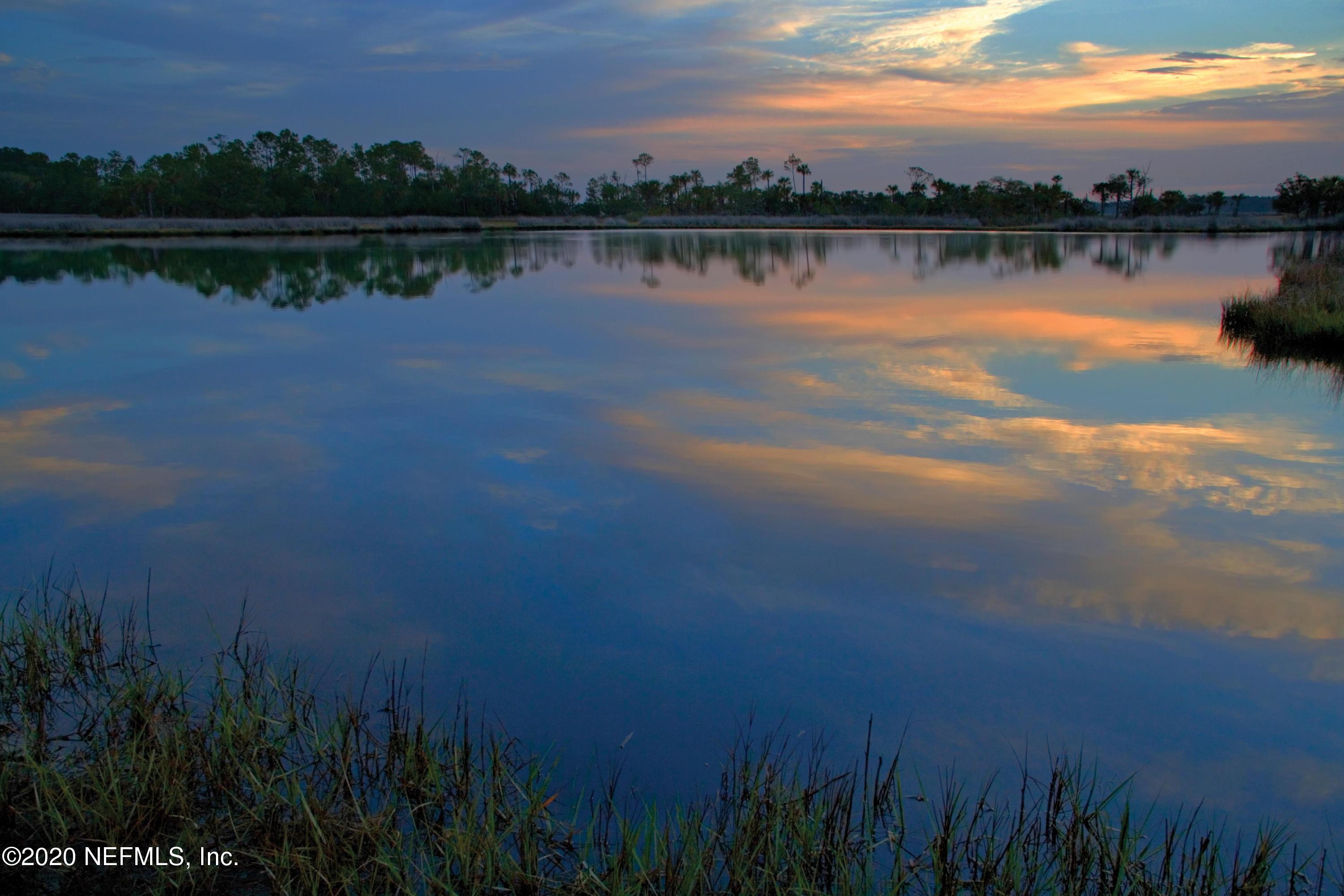 40 Pelican Pointe Road Ponte Vedra, FL 32081 - Photo 42 of 45 a view of a lake with houses in background