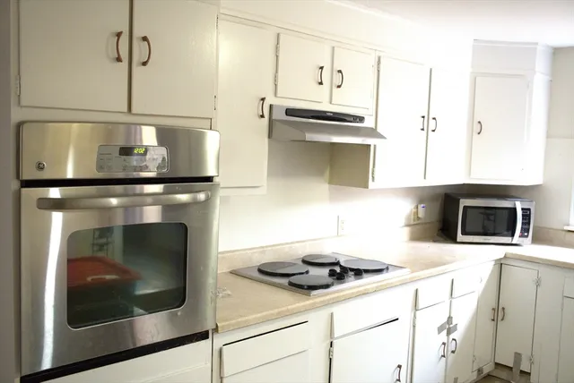 a kitchen with a stove and a microwave