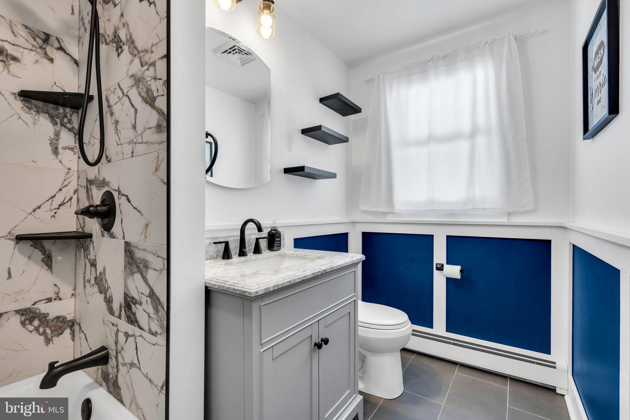 46 Sunset Avenue Hamilton, NJ 08610 - Photo 15 of 28 a bathroom with a granite countertop sink a toilet and a mirror
