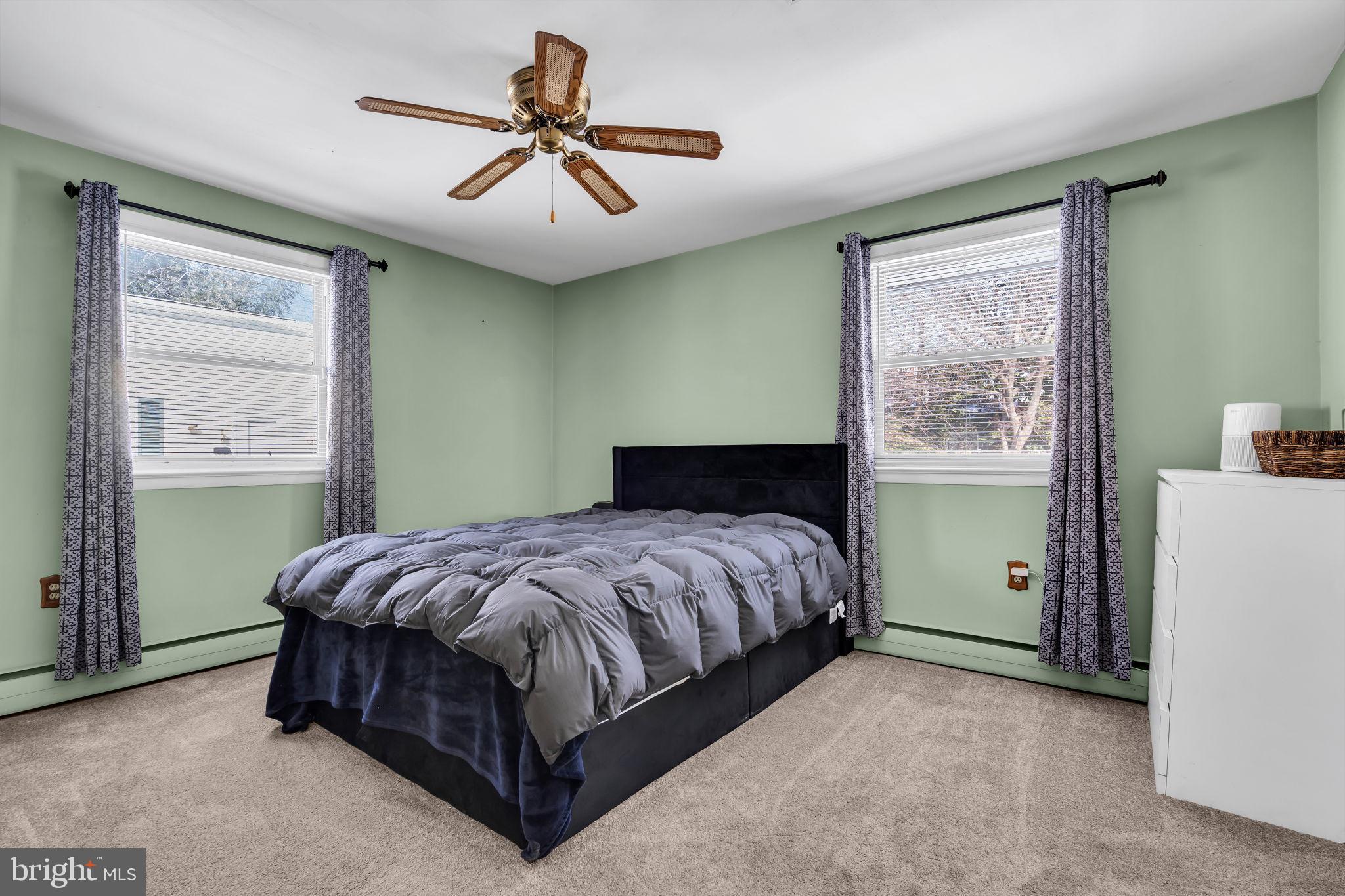 46 Sunset Avenue Hamilton, NJ 08610 - Photo 19 of 28 a spacious bedroom with a bed and a chandelier