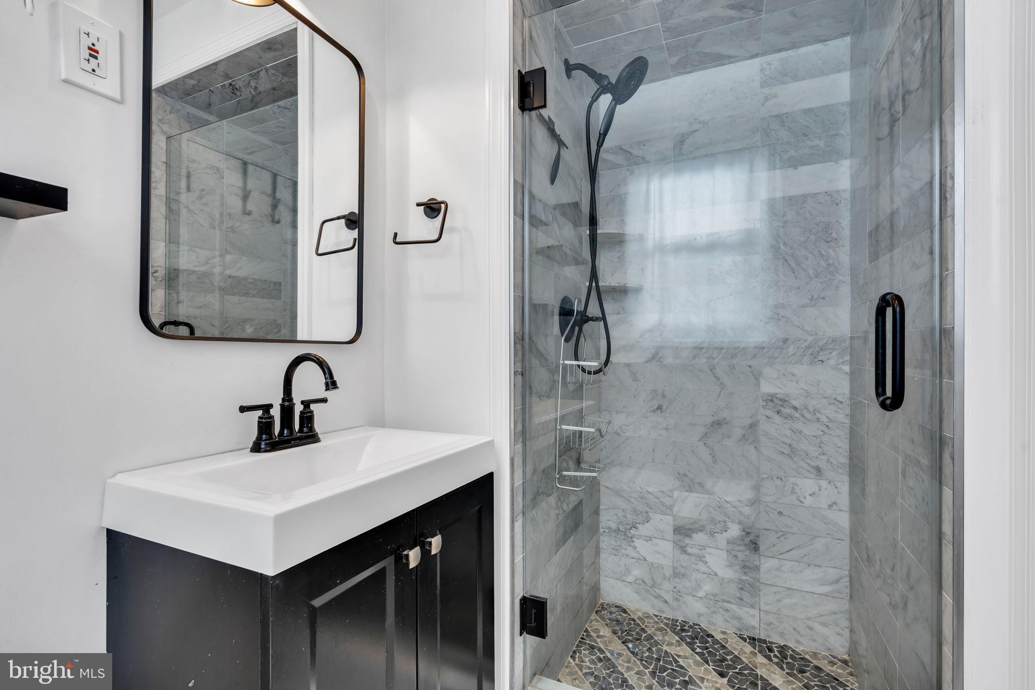 46 Sunset Avenue Hamilton, NJ 08610 - Photo 21 of 28 a bathroom with a sink mirror and shower