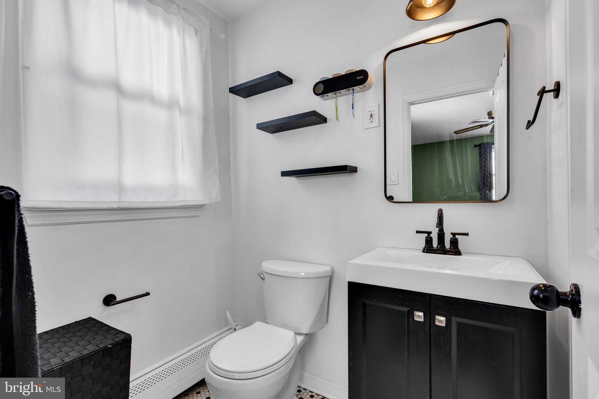 46 Sunset Avenue Hamilton, NJ 08610 - Photo 22 of 28 a bathroom with a sink a toilet and mirror