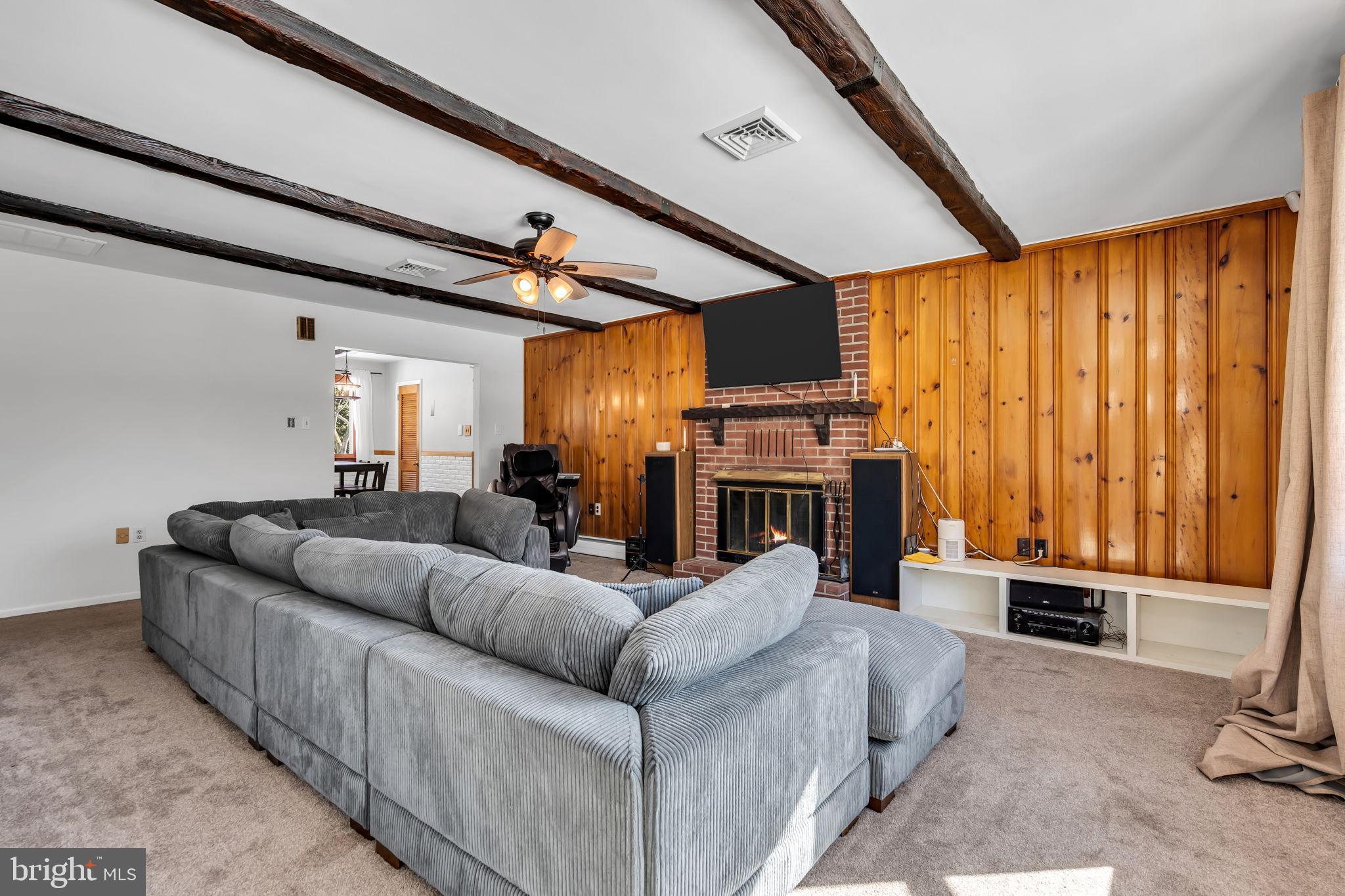 46 Sunset Avenue Hamilton, NJ 08610 - Photo 5 of 28 a living room with furniture a fireplace and a flat screen tv