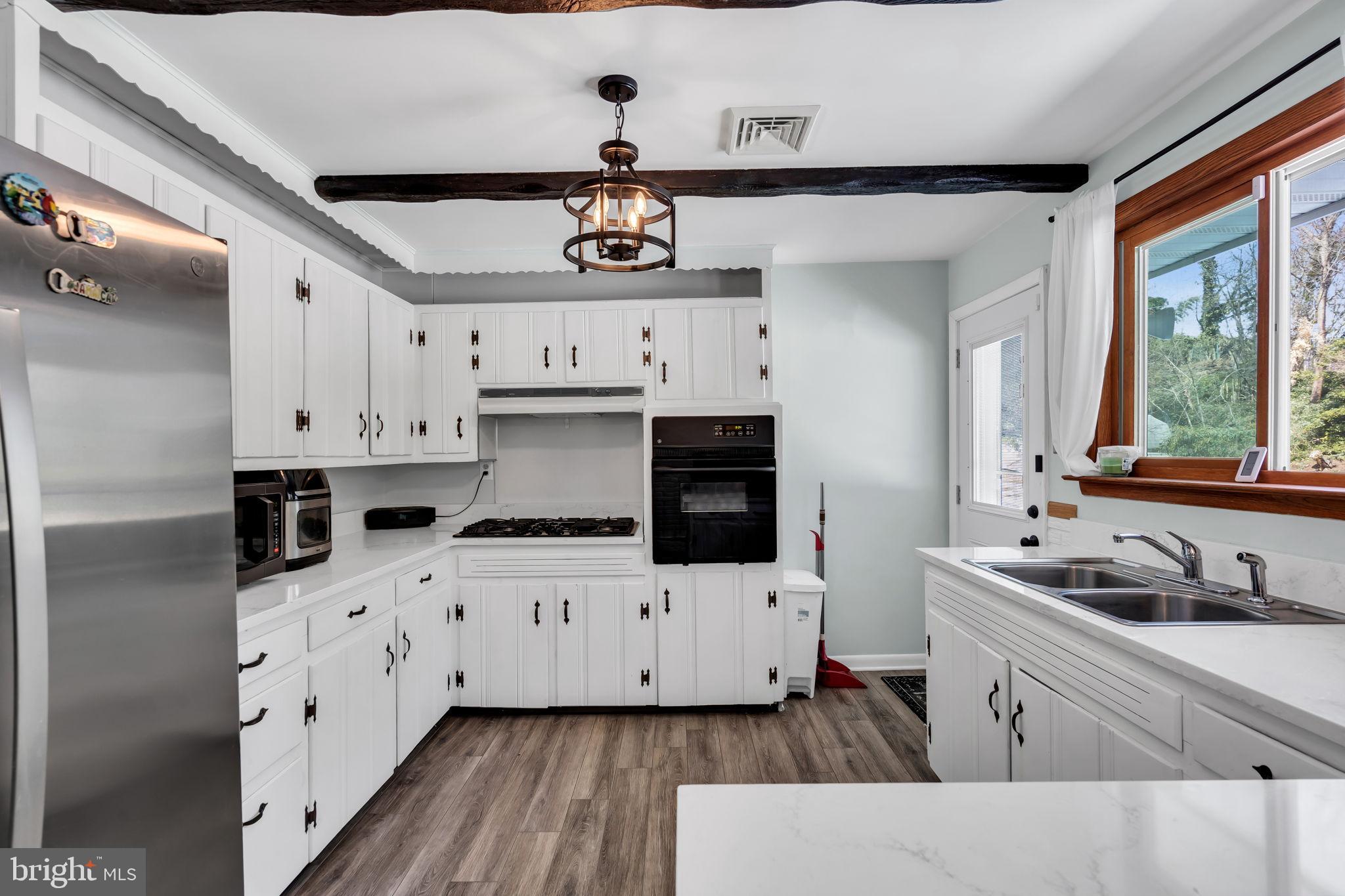 46 Sunset Avenue Hamilton, NJ 08610 - Photo 9 of 28 a kitchen with stainless steel appliances a stove a sink and a refrigerator
