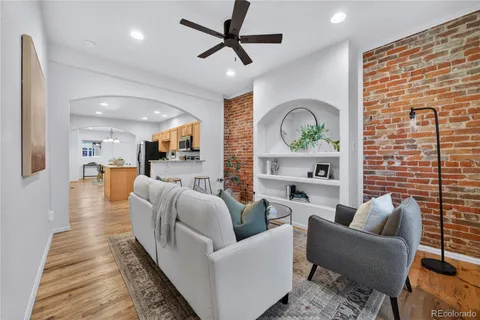 a living room with furniture wooden floor and a fireplace