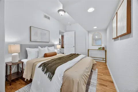 a bed room with a bed and a painting