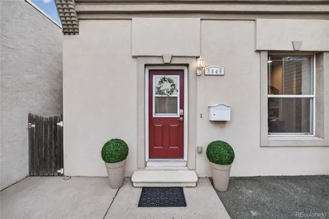 a view of an entryway with wooden floor and front door