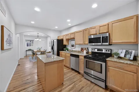 a kitchen with sink a microwave and cabinets