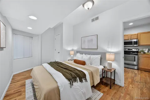 a bedroom with a bed and wooden floor