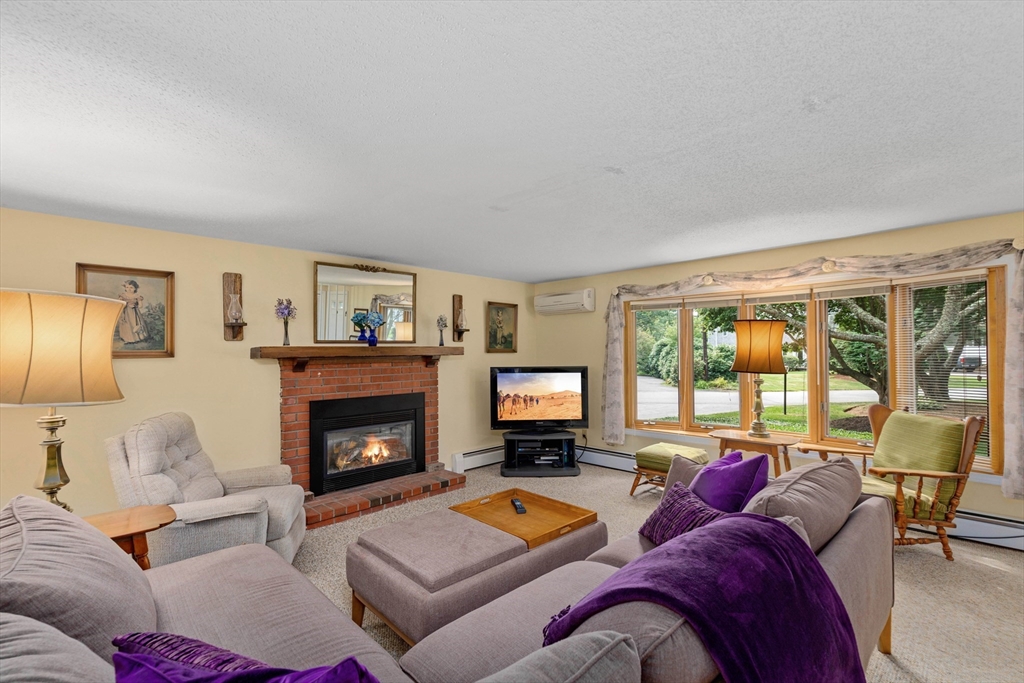 140 Rolling Hitch Road Barnstable, MA 02632 - Photo 13 of 36 a living room with furniture and a fireplace
