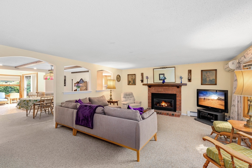 140 Rolling Hitch Road Barnstable, MA 02632 - Photo 15 of 36 a living room with furniture a fireplace and a flat screen tv
