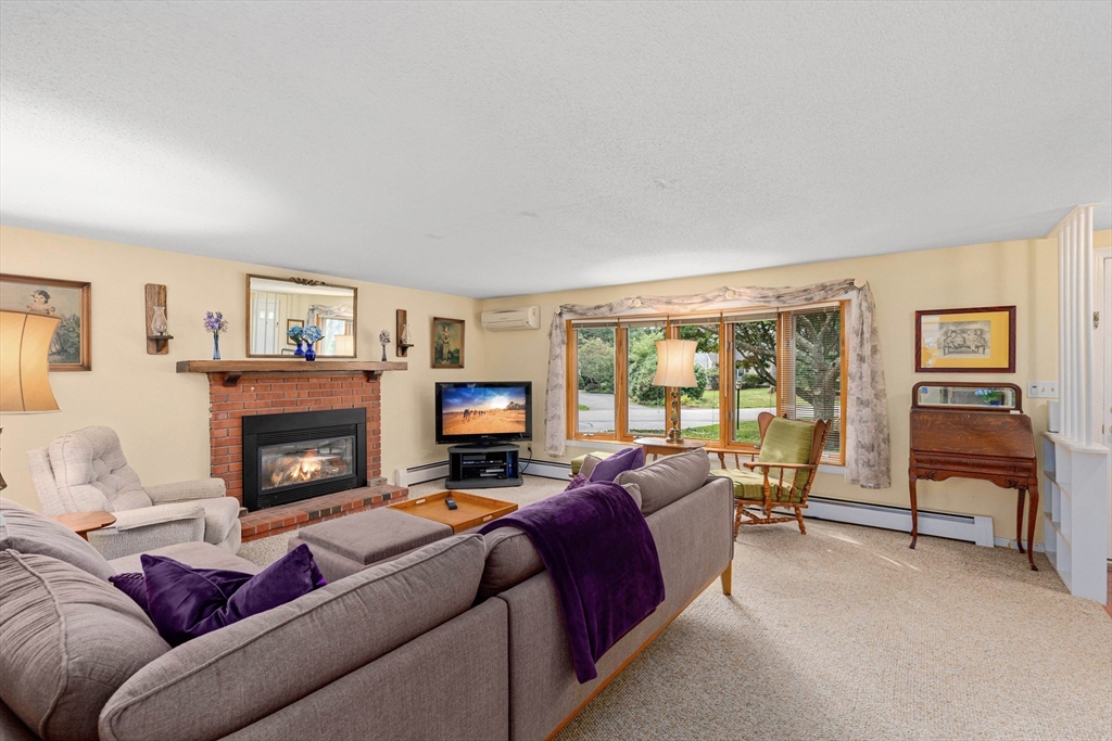 140 Rolling Hitch Road Barnstable, MA 02632 - Photo 16 of 36 a living room with furniture and a fireplace