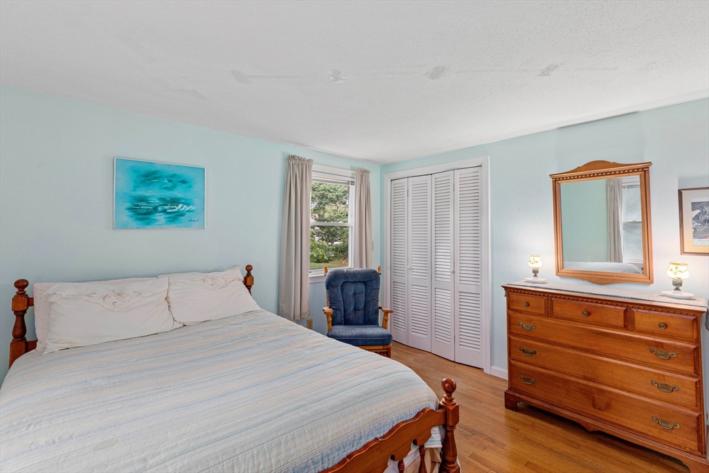 140 Rolling Hitch Road Barnstable, MA 02632 - Photo 19 of 36 a bedroom with a bed and a dresser