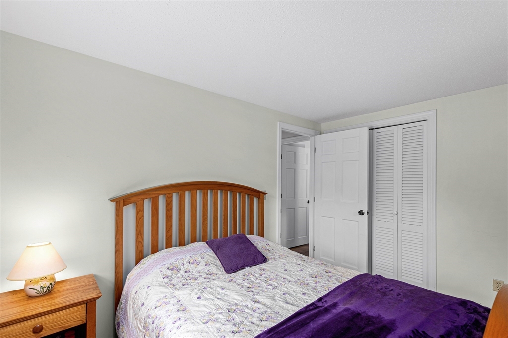 140 Rolling Hitch Road Barnstable, MA 02632 - Photo 21 of 36 a bedroom with a bed a lamp and a dresser