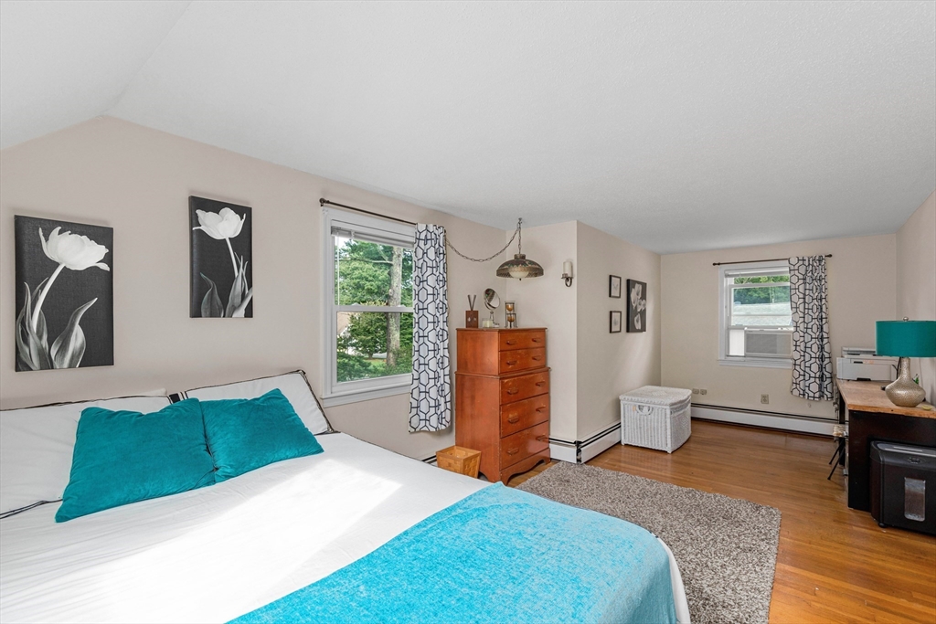 140 Rolling Hitch Road Barnstable, MA 02632 - Photo 27 of 36 a bedroom with a bed and wooden floor