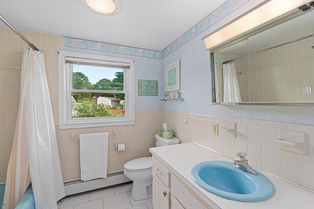 140 Rolling Hitch Road Barnstable, MA 02632 - Photo 29 of 36 a bathroom with a sink a toilet and a mirror