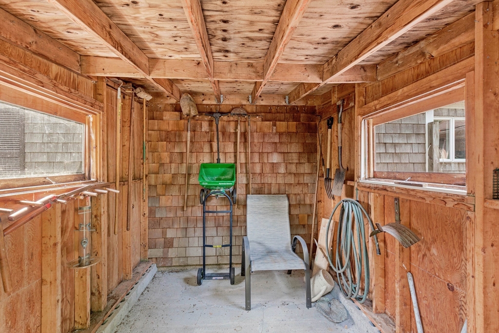 140 Rolling Hitch Road Barnstable, MA 02632 - Photo 34 of 36 a view of a porch with a table and chairs