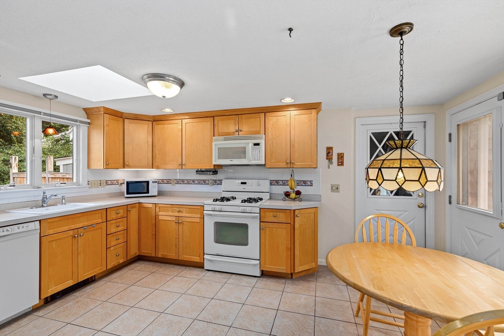 140 Rolling Hitch Road Barnstable, MA 02632 - Photo 5 of 36 a kitchen with stainless steel appliances granite countertop a sink a stove and a wooden floors
