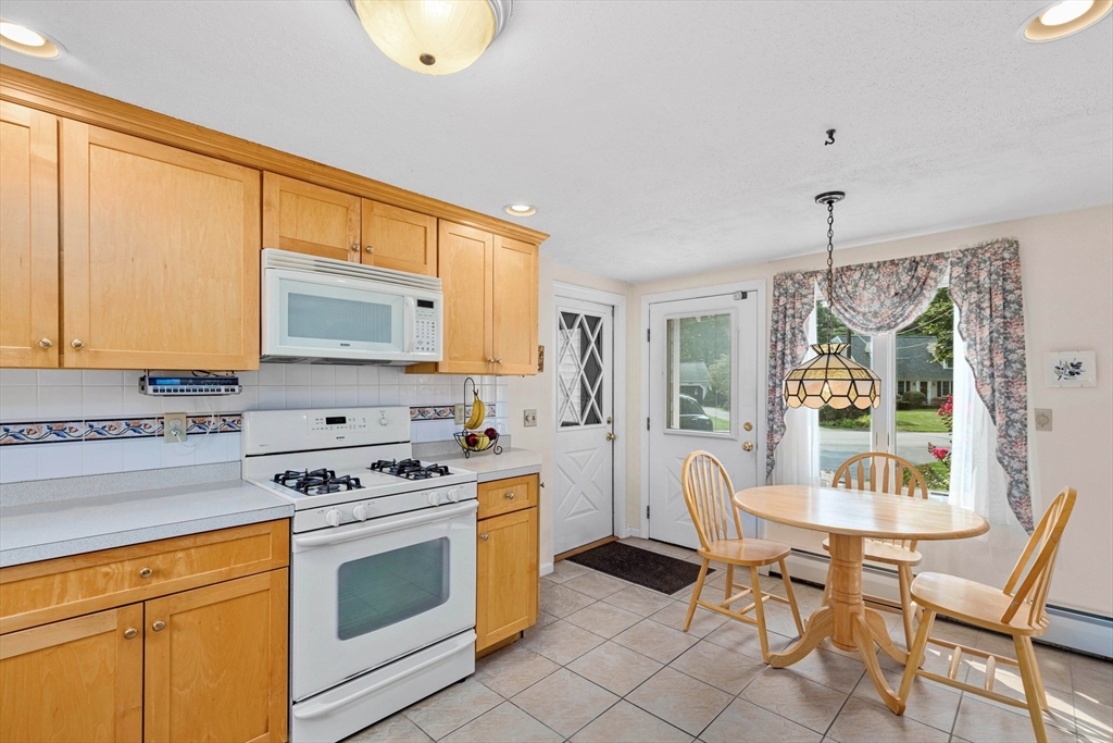 140 Rolling Hitch Road Barnstable, MA 02632 - Photo 6 of 36 a kitchen with stainless steel appliances a stove a sink cabinets and a window