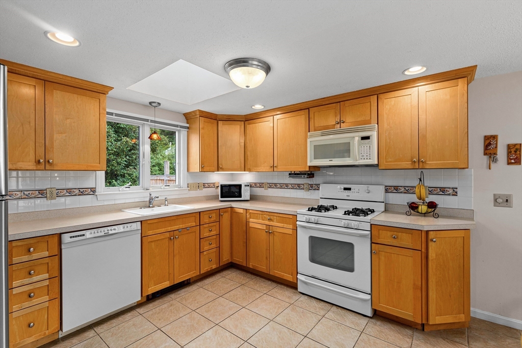 140 Rolling Hitch Road Barnstable, MA 02632 - Photo 7 of 36 a kitchen with a stove sink and cabinets